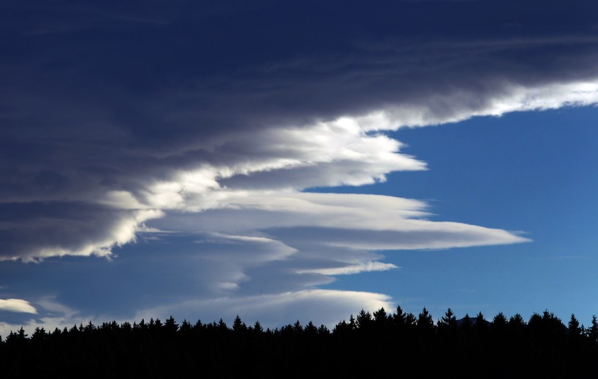 Foehn clouds float over a forest of the alpine upland near Seeg, southern Germany, on November 11, 2014. Foehn is a dry and warm down-slope wind occuring in the lee of a mountain range. AFP PHOTO / DP ...