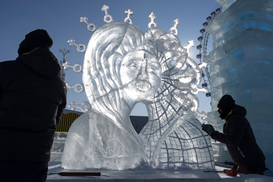 Competitors put the final touches on their piece for the ice sculpture competition at the annual Ice and Snow Festival held in Harbin in China's Heilongjiang province on Sunday, Jan. 4, 2026. (AP ...