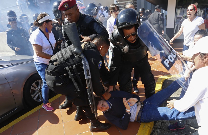 An anti-government protester is dragged away and arrested by police as security forces disrupt an opposition march coined &quot;United for Freedom&quot; in Managua, Nicaragua, Sunday, Oct. 14, 2018. A ...