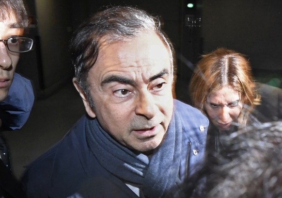 FILE - In this April 3, 2019, file photo, former Nissan Chairman Carlos Ghosn, center, leaves his lawyer&#039;s office in Tokyo. Nissan Chief Executive Hiroto Saikawa has apologized to shareholders fo ...