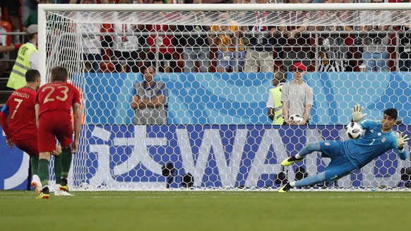 epa06840161 Goalkeeper Ali Beiranvand of Iran saves a penalty of Cristiano Ronaldo (L) during the FIFA World Cup 2018 group B preliminary round soccer match between Iran and Portugal in Saransk, Russi ...