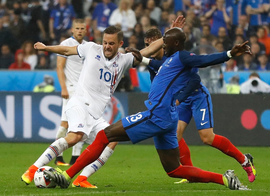 FILE - In this Sunday, July 3, 2016 file photo, Iceland&#039;s Gylfi Sigurdsson, left, and France&#039;s Eliaquim Mangala challenge for the ball during the Euro 2016 quarterfinal soccer match between  ...