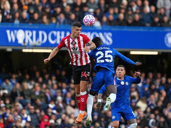 Sunderland's Granit Xhaka, left, jumps for the ball with Chelsea's Moises Caicedo while Chelsea's Enzo Fernandez looks on during the English Premier League soccer match between Chelsea  ...