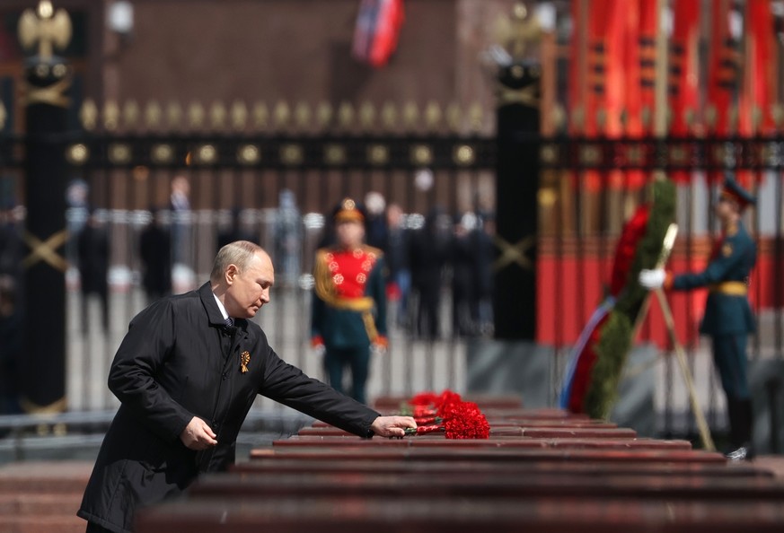 Russian President Vladimir Putin attends a wreath-laying ceremony at the Tomb of the Unknown Soldier after the military parade marking the 77th anniversary of the end of World War II in Moscow, Russia ...