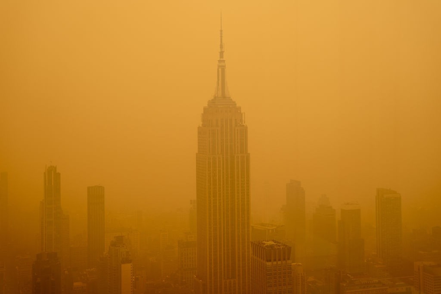 NEW YORK, NEW YORK - JUNE 7: Smoky haze from wildfires in Canada diminishes the visibility of the Empire State Building on June 7, 2023 in New York City. New York topped the list of most polluted majo ...