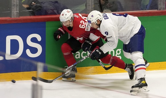 Switzerland&#039;s Denis Malgin is challenged by France&#039;s Damien Fleury during the group A Hockey World Championship match between Switzerland and France in Helsinki, Finland, Sunday May 22 2022. ...