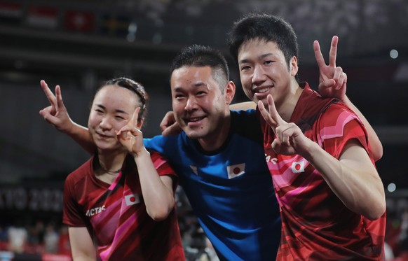 epa09367843 Jun Mizutani (R) and Mima Ito (L) of Japan.react after winning the Gold Medal at the Mixed Doubles Gold Medal Table Tennis Match China vs Japan of the Tokyo 2020 Olympic Games at the Tokyo ...