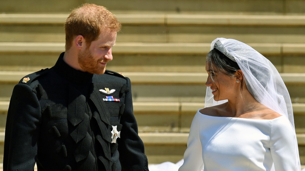 FILE - Prince Harry and Meghan Markle walk down the steps after their wedding at St. George's Chapel in Windsor Castle in Windsor, near London, England, Saturday, May 19, 2018. Britain