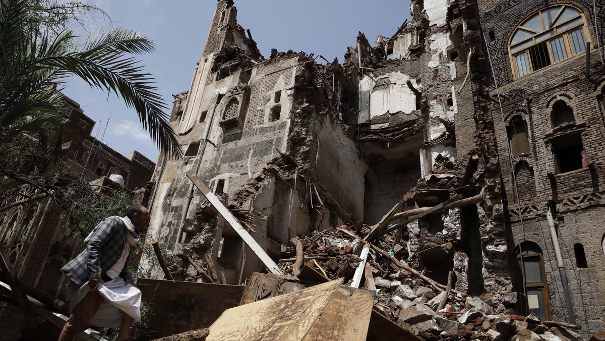 epa10114285 A Yemeni inspects a rains-collapsed UNESCO-listed building in the old quarter of Sana'a, Yemen, 10 August 2022. Torrential rains have hit Yemen over the past two weeks, causing damage ...