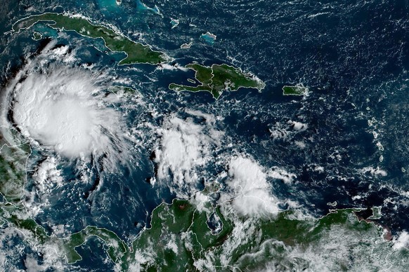 This satellite image taken at 8:40am ET and provided by NOAA shows Tropical Storm Lisa under Cuba in the Caribbean Sea, Tuesday, Nov. 1, 2022. Lisa is forecast to make landfall in Central America late ...