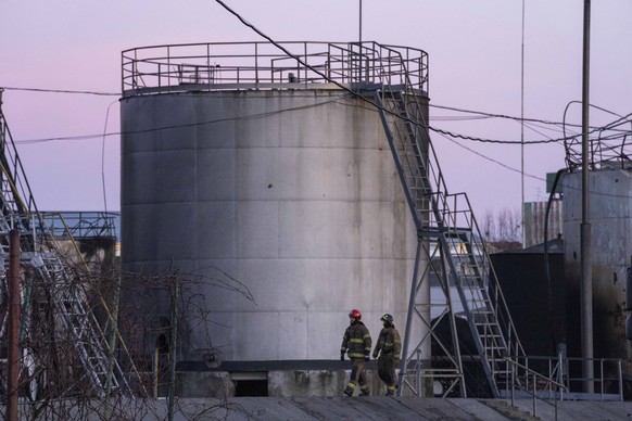Firefighters work at the site in the aftermath of the first strike that involved Russian rockets that hit an oil facility in an industrial area in the northeastern outskirts of Lviv, Ukraine, Sunday,  ...
