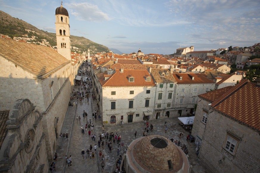 In this Sept. 7, 2018 photo, tourists walk through Dubrovnik old town. Crowds of tourist are clogging the entrances into the ancient walled city, a UNESCO World Heritage Site, as huge cruise ships unl ...