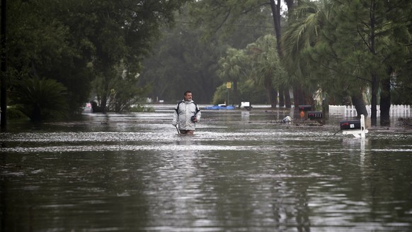 Joey Spalding walks back to his truck down the street where he lives, Monday, Sept. 11, 2017, on Tybee Island, Ga. Spalding just finished repairing his house from nine inches of water after Hurricane  ...