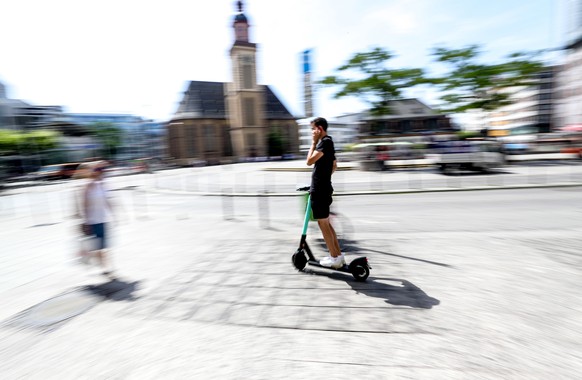 epa07672486 A man uses a e-scooter in downtown Frankfurt Main, Germany, 25 June 2019. &#039;Tier Mobility&#039; company starts the business of renting e-scooters since last weekend. The company is alr ...