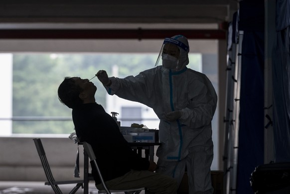 epa08878503 A taxi driver receives a PCR test for coronavirus (COVID-19) at a Community Testing Centre in Hong Kong, China, 12 December 2020. The Hong Kong government has imposed tighter COVID-19 soci ...