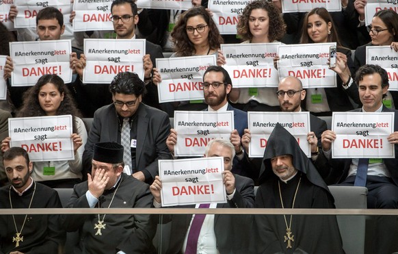 epa05342212 Members of the Armenian initiative &#039;Anerkennung jetzt&#039; (lit. Recognition now) hold up signs reading &#039;thank you&#039; after the vote on a resolution to classify the 1915-16 m ...