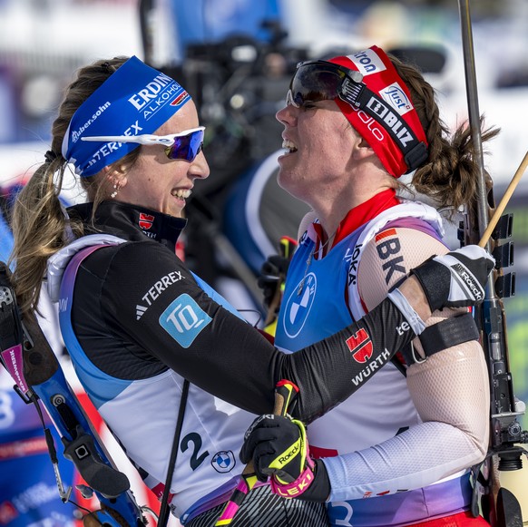 Franziska Preuss of Germany, left, reacts with Lena Haecki-Gross of Switzerland, right, at the finish line during the women?s 10k pursuit race at the IBU Biathlon World Championships, on Sunday, Febru ...