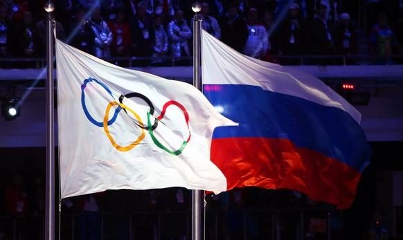 epa06369455 (FILE) - The Olympic flag (L) and the Russian flag (R) during the Closing Ceremony of the Sochi 2014 Olympic Games in the Fisht Olympic Stadium in Sochi, Russia, 23 February 2014 (reissued ...