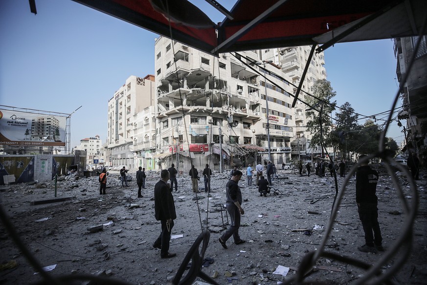 epa07548020 Palestinians inspect rubble of a destroyed building damaged after an Israeli air strike in Gaza City, 05 May 2019. Media reports state that more than 250 rockets have been fired into Israe ...