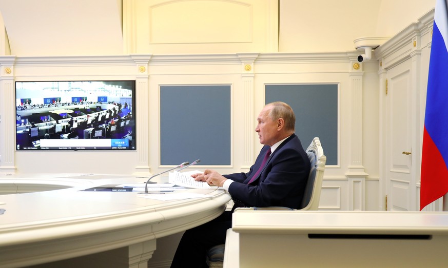 Russian President Vladimir Putin speaks as he attends the G20 summit via videoconference in Moscow, Russia, Saturday, Oct. 30, 2021. The two-day Group of 20 summit is the first in-person gathering of  ...