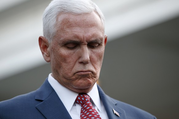 Vice President Mike Pence listens as Treasury Secretary Steven Mnuchin, speaks to reporters outside the West Wing of the White House, Monday, Oct. 14, 2019, in Washington. The U.S. is calling for an i ...