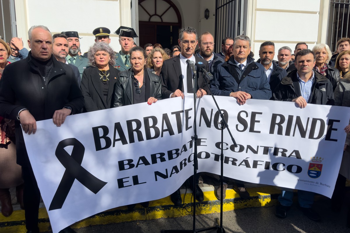 epa11142494 People holding a banner reading 'Barbate does not surrender. Barbate against drug trafficking' observe a minute of silence in Barbate town in Cadiz province on 10 February 2024,  ...