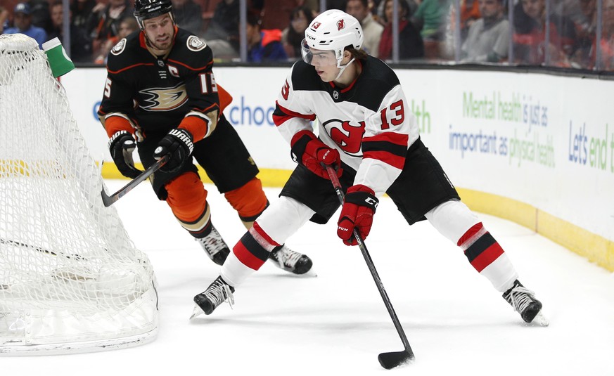 New Jersey Devils&#039; Nico Hischier, of Switzerland, moves the puck past Anaheim Ducks&#039; Ryan Getzlaf during the first period of an NHL hockey game Sunday, March 18, 2018, in Anaheim, Calif. (AP ...