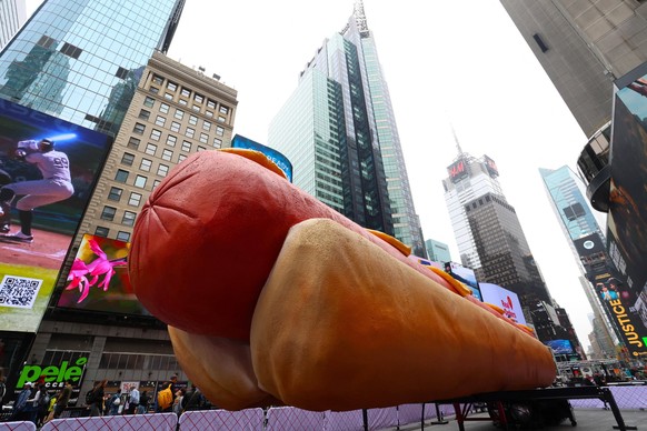 Hot Dog Artwork In Times Square - NYC Giant 65-foot-long Hot dog artwork by Brooklyn-based artist duo Jen Catron and Paul Outlaw stands on the middle of Times Square in New York City, NY, USA on April ...