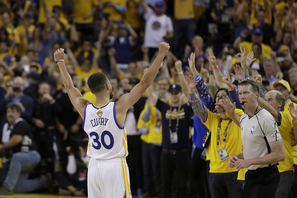 Golden State Warriors guard Stephen Curry (30) celebrates with fans after Game 5 of basketball&#039;s NBA Finals between the Warriors and the Cleveland Cavaliers in Oakland, Calif., Monday, June 12, 2 ...