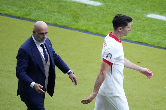FILE - Poland&#039;s Robert Lewandowski, right, walks by Poland&#039; head coach Michal Probierz, left, during a Group D match between Poland and Austria at the Euro 2024 soccer tournament in Berlin,  ...
