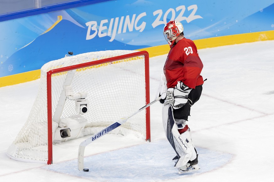 Switzerland&#039;s goaltender Reto Berra reacts after taking his third goal, during the men&#039;s ice hockey preliminary round game between Switzerland and Denmark at the Wukesong Sports Centre at th ...