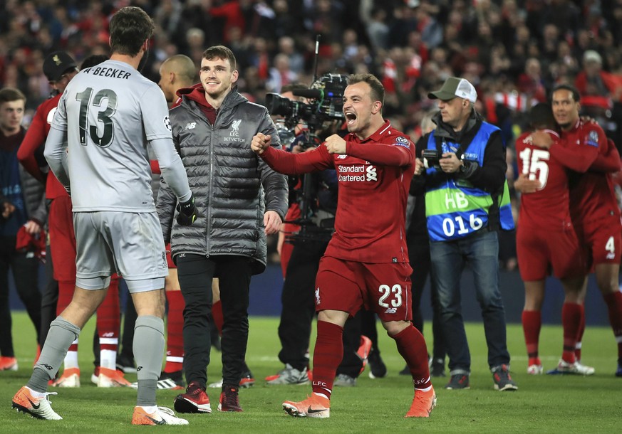 Liverpool's Xherdan Shaqiri and Alisson Becker celebrate after the Champions League Semi Final, second leg soccer match between Liverpool and Barcelona at Anfield, Liverpool, England, Tuesday, Ma ...