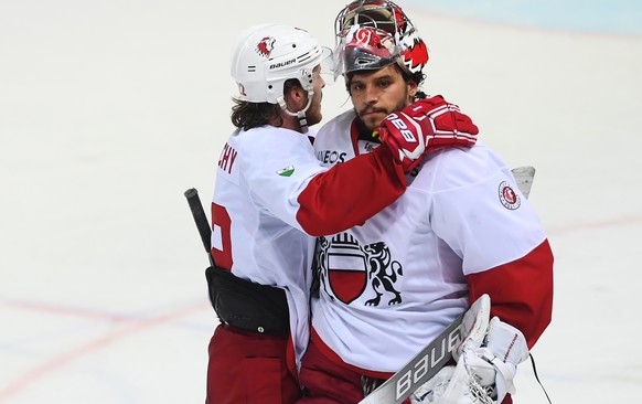 Lausanne&#039;s player Christoph Bertschy with the disappointed Lausanne&#039;s goalkeeper Luca Boltshauser at the end of the regular season game of the National League Swiss Championship 2018/19 betw ...