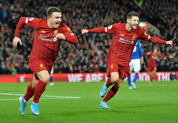 epa08045020 Xherdan Shaqiri (L) of Liverpool celebrates with teammate Adam Lallana after scoring the 2-0 during the English Premier League soccer match between Liverpool FC and Everton in Liverpool, B ...