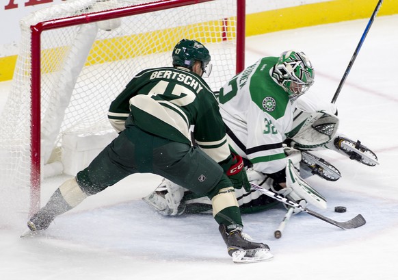 Dallas Stars goalie Kari Lehtonen, of Finland (32) stops a shot by Minnesota right wing Christoph Bertschy (47) during the third period of an NHL game, Saturday, Oct. 29, 2016, in St. Paul, Minn. Minn ...