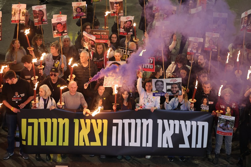 epa11826740 Family members of hostages held by Hamas in Gaza and their supporters light torches as they react to ceasefire reports during a protest calling for a ceasefire and for the release of the h ...