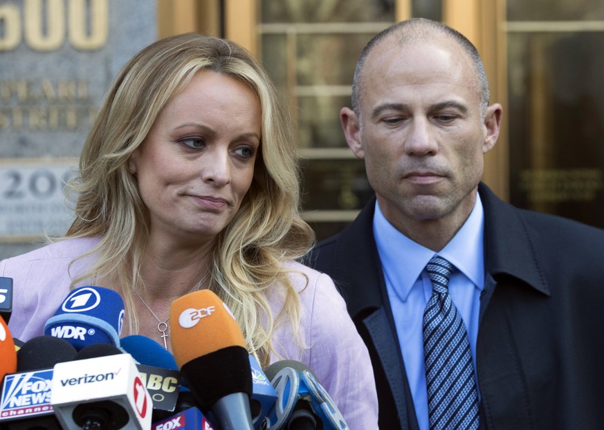 FILE - In this April 16, 2018, file photo, adult film actress Stormy Daniels, left, stands with her lawyer Michael Avenatti as she speaks outside federal court in New York. The story told by President ...