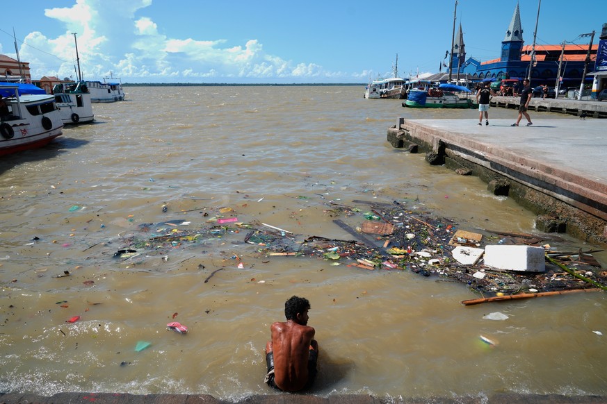 A man sits in a river amid the nearby COP30 U.N. Climate Summit, Saturday, Nov. 8, 2025, in Belem, Brazil. (AP Photo/Fernando Llano)
COP30 Climate Summit