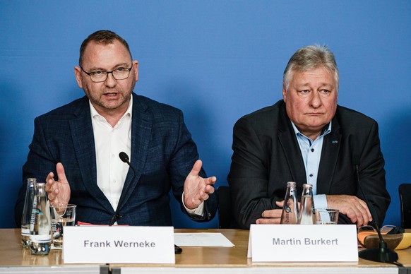 epa10538597 Chairman of the Ver.di trade union Frank Werneke (L) and chariman of the Railroad and Transport Union EVG Martin Burkert look on during a press conference in Berlin, Germany, 23 March 2023 ...