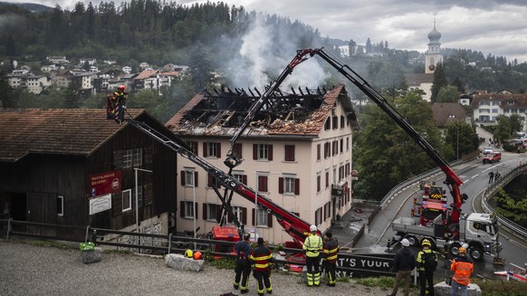 epa13182442 Firefighters try to put out a fire at a building with a restaurant and apartments in Thusis in eastern Switzerland, 21 August 2026. Five people are reported missing following a major fire, ...