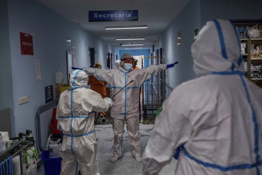 FILE - In this Oct. 9, 2020, file photo, a medical team member is disinfected before leaving the COVID-19 ward at the Severo Ochoa hospital in Leganes, outskirts of Madrid, Spain. Europe