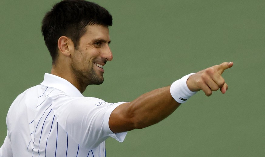 epa08634587 Novak Djokovic of Serbia celebrates winning against Milos Raonic of Canada during their Menss finals match at the Western and Southern Open at the USTA National Tennis Center in Flushing M ...