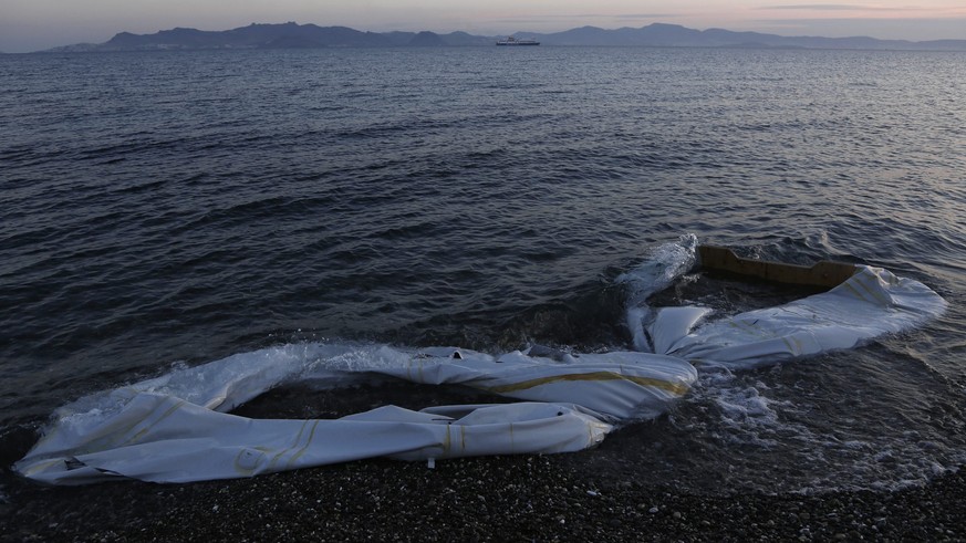 epa04754668 (30/30) Half sunk inflatable boats are washed ashore at the coast of Kos island, near the sea border with Turkey, Greece, 04 May 2015. The boats were used by refugees to disembark on the c ...