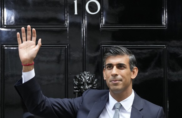 FILE - New British Prime Minister Rishi Sunak waves after arriving at Downing Street in London, Tuesday, Oct. 25, 2022, after returning from Buckingham Palace where he was formally appointed to the po ...