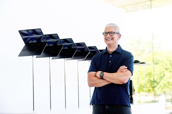 Apple CEO Tim Cook stands in front of a display of new Apple MacBook Air computers with M2 processors, Monday, June 6, 2022, following the keynote presentation of Apple&#039;s World Wide Developer Con ...