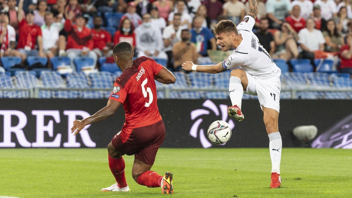 Italy's Ciro Immobile, right, shoots next to Switzerland's Manuel Akanji, during the 2022 FIFA World Cup European Qualifying Group C soccer match between Switzerland and Italy at the St. Jak ...
