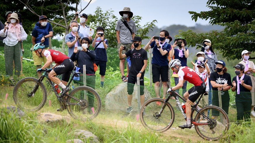 Nino Schurter, left, of Switzerland and Mathias Flueckiger, right, of Switzerland compete during the men&#039;s Cross-country Mountain Bike, MTB, race at the 2020 Tokyo Summer Olympics in Izu near Tok ...