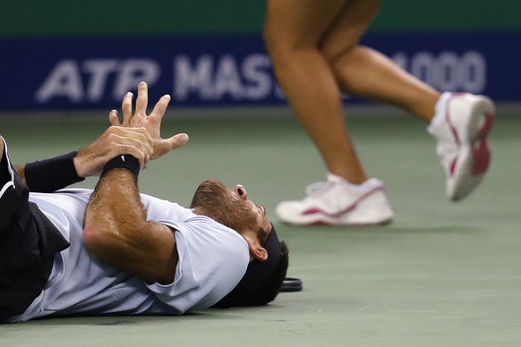 Juan Martin del Potro of Argentina holds his hand in pain after he fell during his men&#039;s singles quarterfinals match against Viktor Troicki of Serbia in the Shanghai Masters tennis tournament at  ...