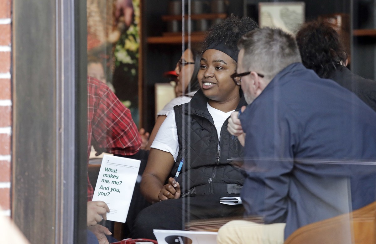 People are seen meeting inside the ground floor, closed Starbucks Reserve at the company's headquarters during employee anti-bias training, Tuesday, May 29, 2018, in Seattle. Starbucks closed mor ...