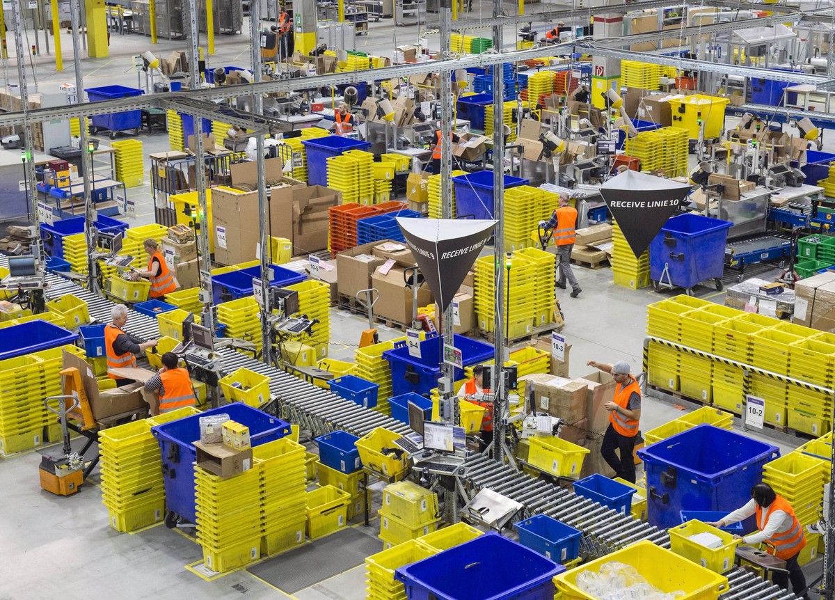 Employees work in the distribution center of the online retailer Amazon during a guided press tour prior to the upcoming Christmas business in Leipzig, central Germany, Thursday, Nov. 19, 2015. Amazon ...